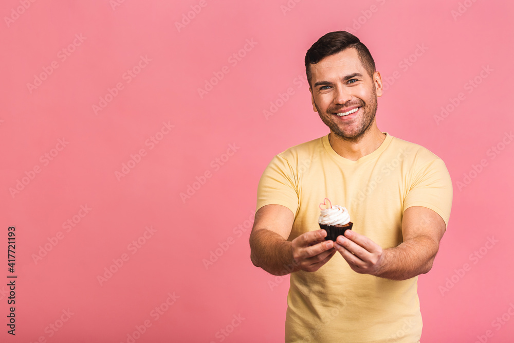 Diet concept! Happy smiling bearded man eating chocolate cake isolated over pink background. Diet concept! Happy smiling bearded man eating chocolate cake isolated over pink background.
