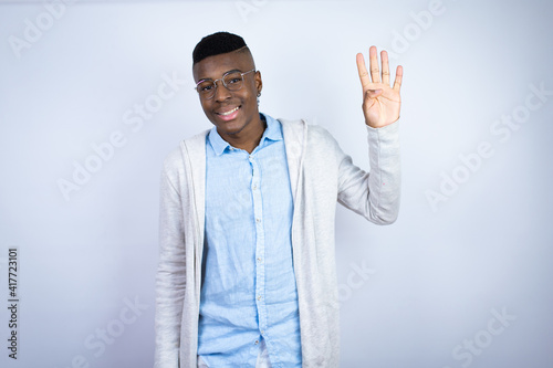 Young handsome african american man wearing casual clothes showing and pointing up with fingers number four while smiling confident and happy © Irene
