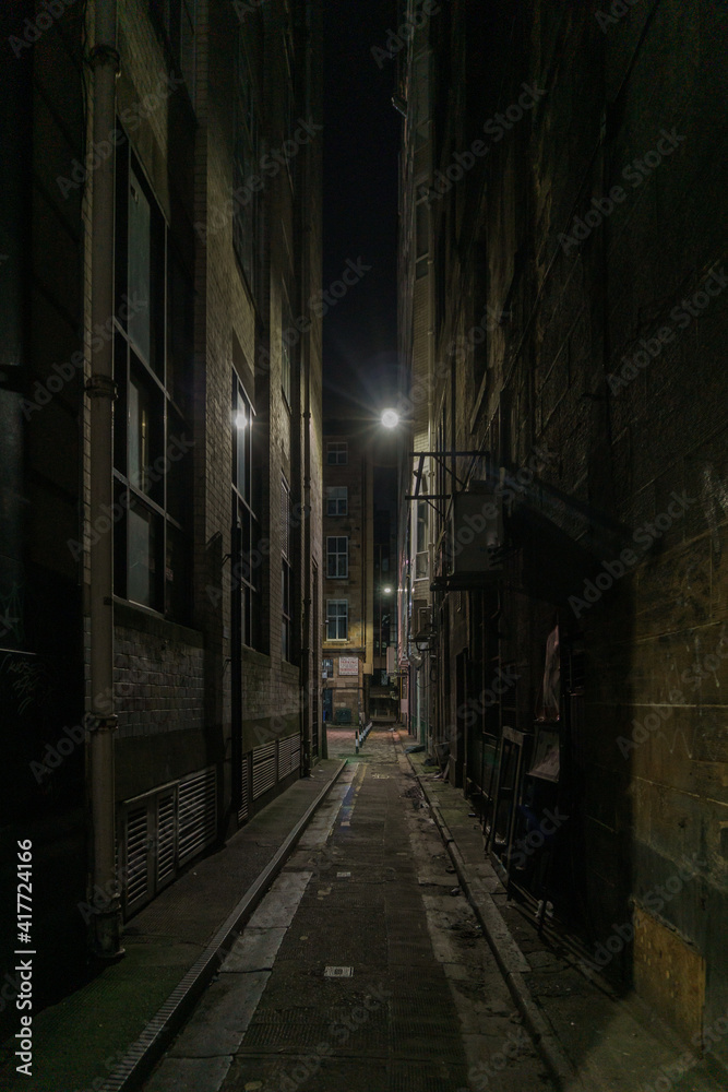 Fototapeta A narrow alley at night