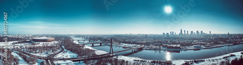 Beautiful panoramic winter aerial drone view to Warsaw city center with skyscrapers and Swietokrzyski Bridge (En: Holy Cross Bridge) - is a cable-stayed bridge over the Vistula river in Warsaw, Poland © udmurd