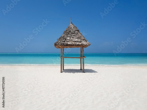 thatched beach canopy or parasol on the beach  ocean  empty beach