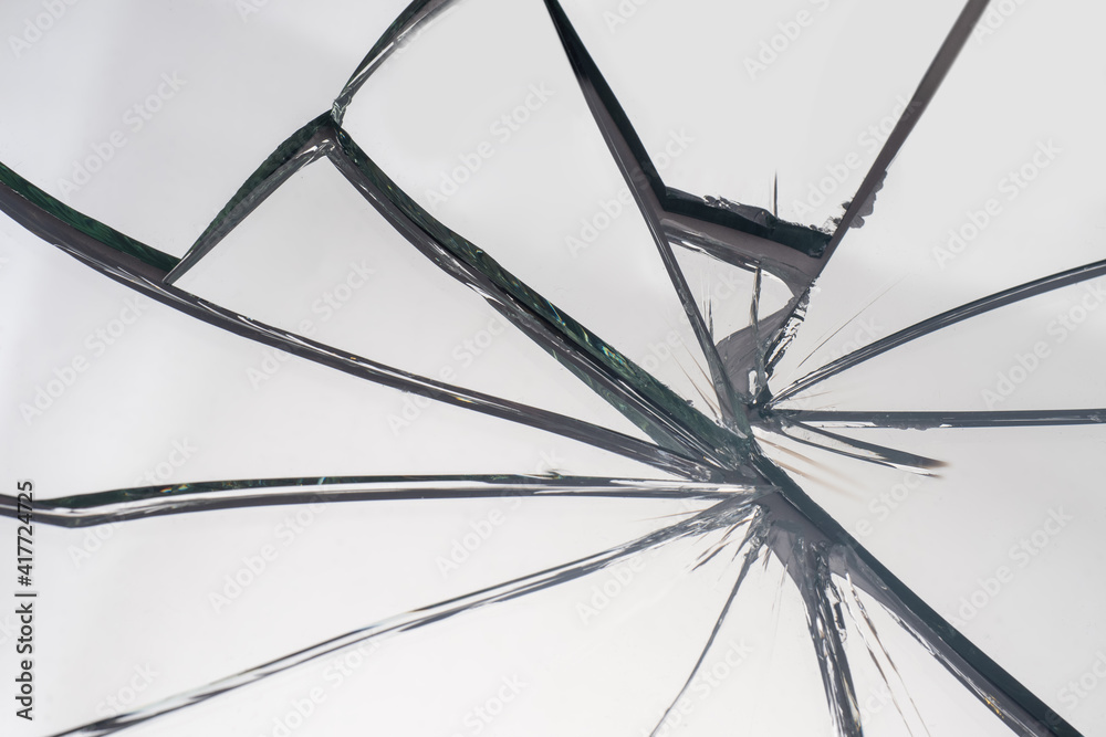 Broken glass with cracks. The mirror shattered into fragments. Cracks ...