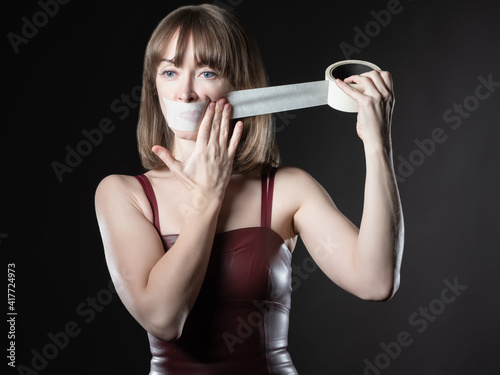 The woman covers her mouth....