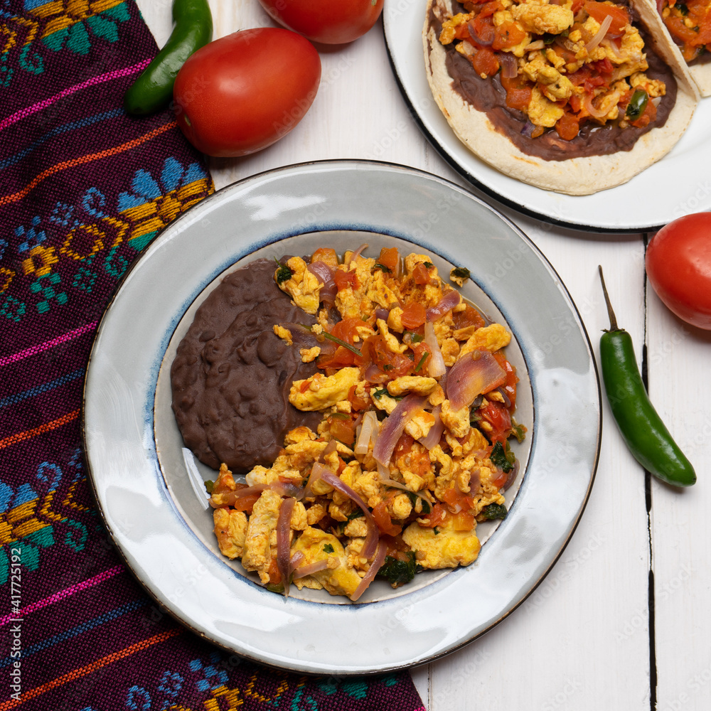 Scrambled eggs and refried beans tacos on white background. Mexican food Scrambled eggs and refried beans tacos on white background. Mexican food