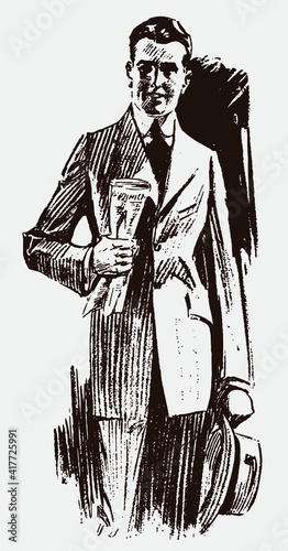 Friendly smiling young man from the early 20th century in frontal view, wearing suit, holding hat and rolled up newspaper