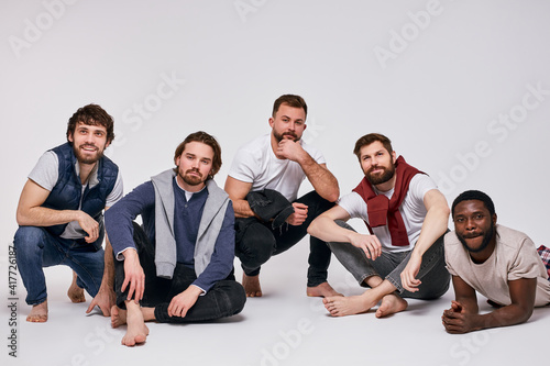 group of young diverse young men isolated on white background, mixed race male models in stylish casual clothes posing at camera