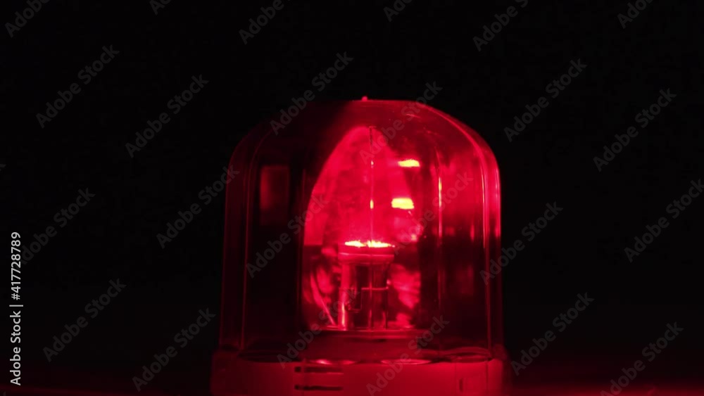 Emergency rotating alarm red light at night.