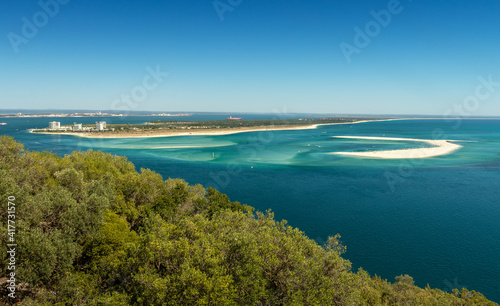 Beautiful landscape of the Tróia Peninsula in Portugal, with its beaches bathed by the blue and turquoise waters of the Atlantic Ocean, seen from the Serra da Arrábida on a summer day.