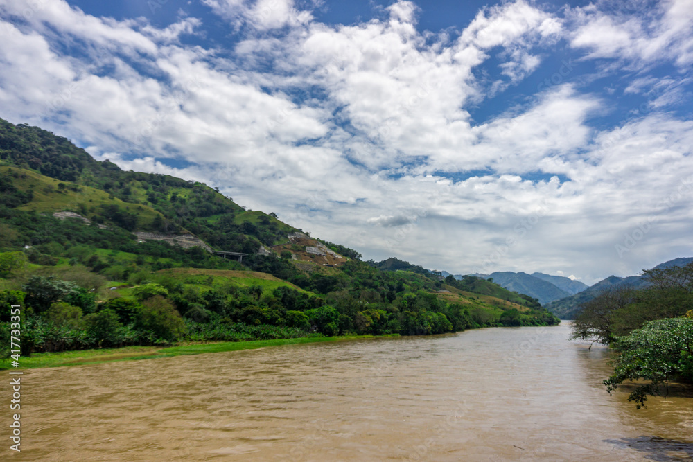 Fototapeta premium deep blue sky with abudant riven in the forest cauca rives