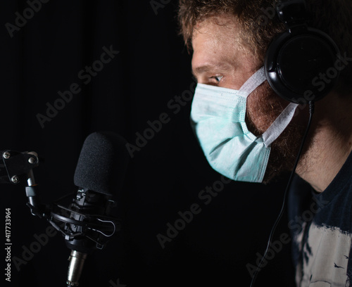 Man podcasting with a mask on