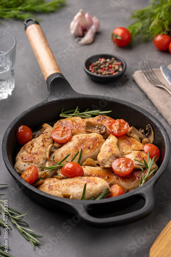 Grilled chicken breast or fillet with tomato on iron pan. High quality photo