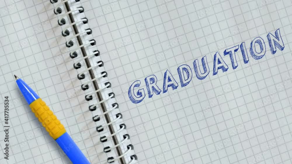 Text GRADUATION handwritten on sheet of notebook. Text GRADUATION handwritten on sheet of notebook.