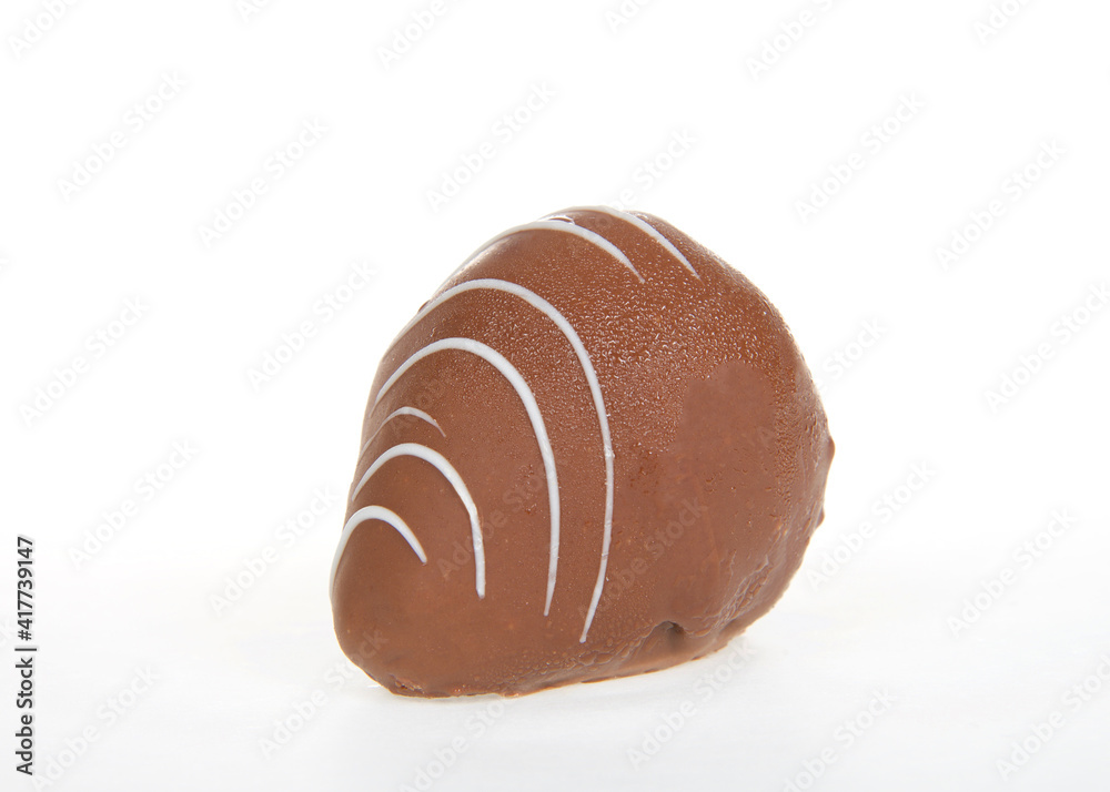 Close up on giant strawberry dipped completely in milk chocolate, drizzled with contrasting white chocolate. Isolated on white. Close up on giant strawberry dipped completely in milk chocolate, drizzled with contrasting white chocolate. Isolated on white.