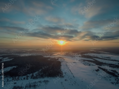 the setting sun illuminates the snowy landscape of central Russia