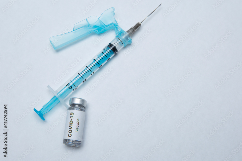 Syringe and vaccine, COVID-19 immunizer, hope for humanity. Syringe and vaccine, COVID-19 immunizer, hope for humanity.