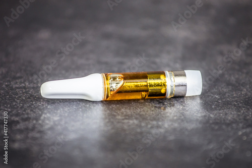 THC / CBD oil vape cartridge isolated macro up-close full gram cannabis oil