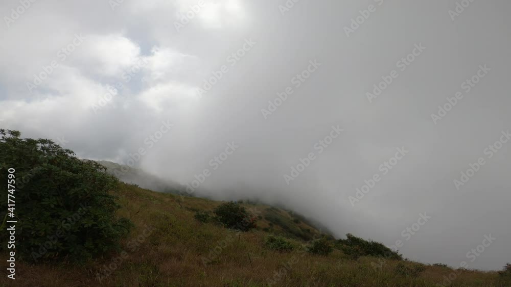 Scenic view of beautiful mountains with fog moving at sunrise. Sea of fog in winter early morning on peak of mountains. Scenic view of beautiful mountains with fog moving at sunrise. Sea of fog in winter early morning on peak of mountains.