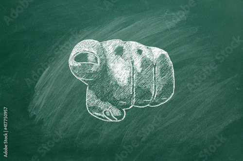 A human hand pointing and gesturing towards to you. Closeup of a human hand pointing at you. Illustration drawn in chalk on a green chalkboard.
