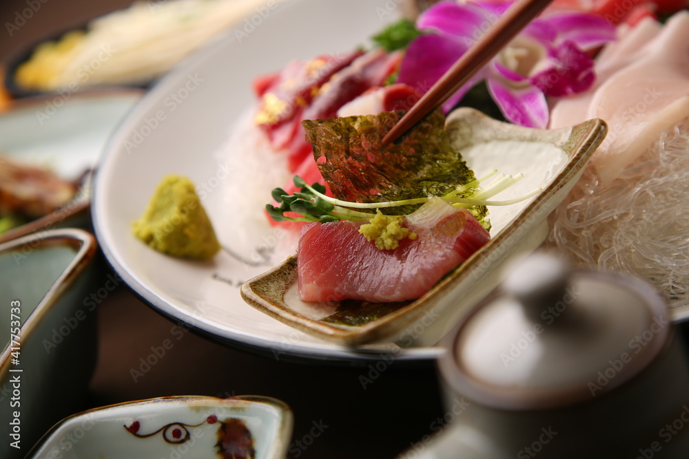 Chopsticks holding sashimi on a simple background 심플한 배경에 회를 집고있는 젓가락 Chopsticks holding sashimi on a simple background 심플한 배경에 회를 집고있는 젓가락