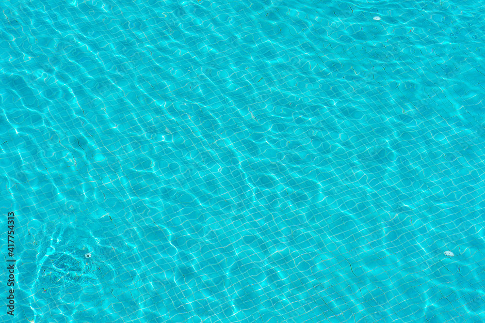 blue swimming pool with sunny reflections abstract for background
