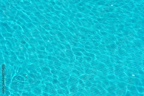 blue swimming pool with sunny reflections abstract for background