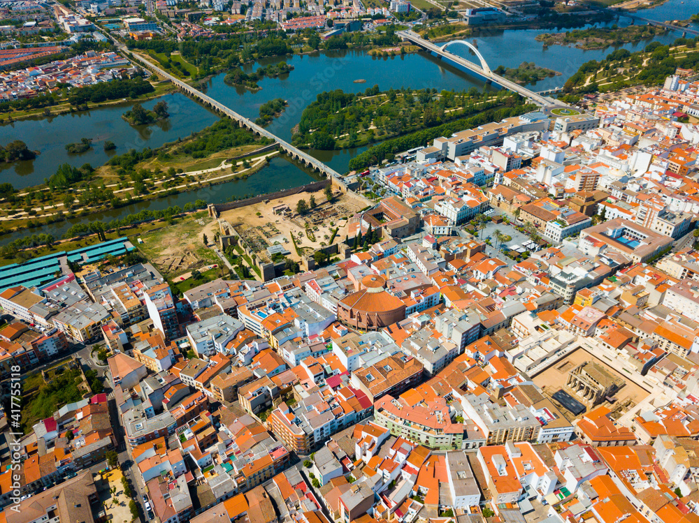 Scenic aerial view of Spanish city of Merida with ancient Roman Bridge and modern Lusitania Bridge over Guadiana river