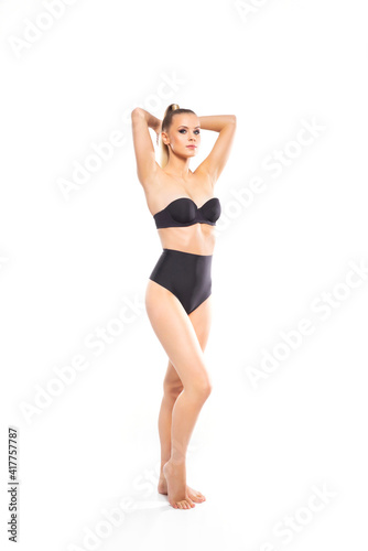 Young, fit and beautiful blond woman in white swimsuit isolated on white background. Healthcare, diet, sport and fitness.