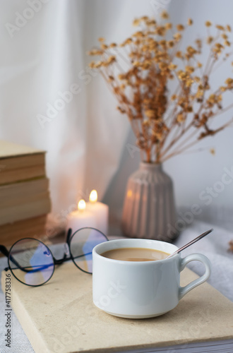 Coffee, books, a bouquet of flowers and candles on the table. Stylish still life. Instagram content