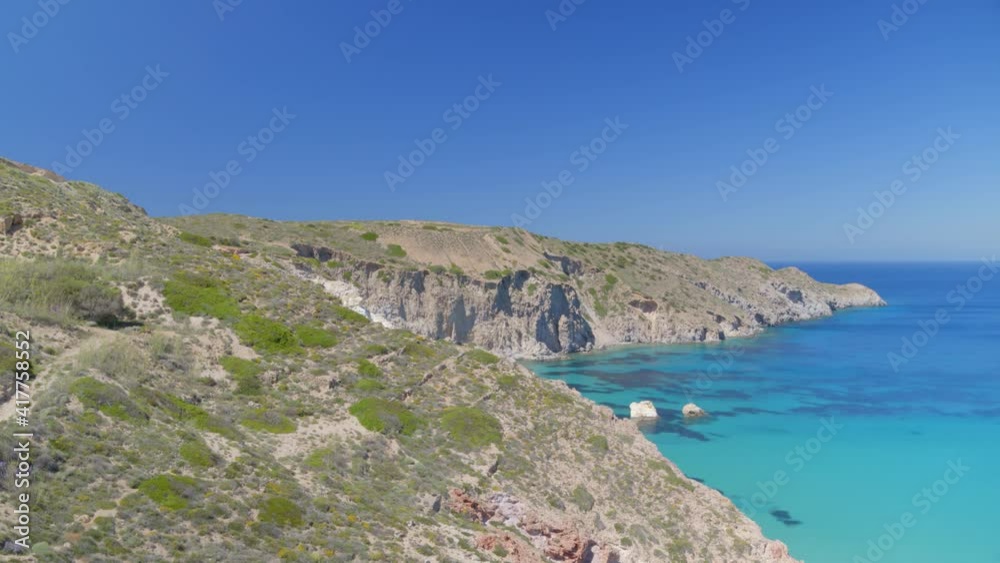 Rising Pan From Cliffs to an Aerial View of the Blue Aegean Sea in Milos Rising Pan From Cliffs to an Aerial View of the Blue Aegean Sea in Milos