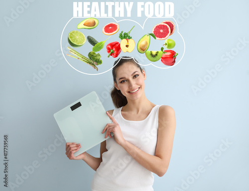 Young woman on diet holding...