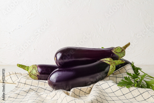 Fresh eggplants on light background