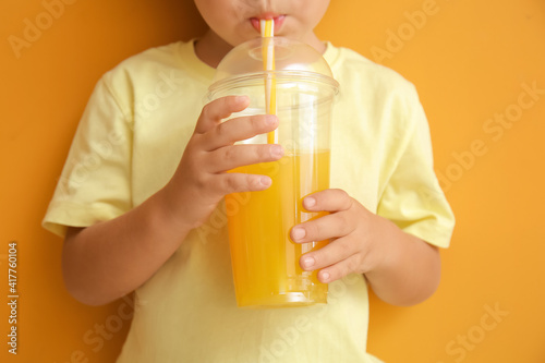 Cute little boy drinking or...