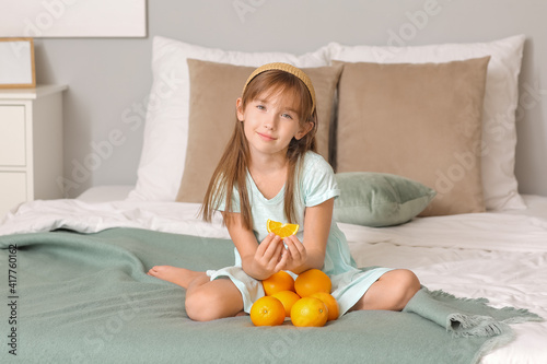 Cute little girl with orang...
