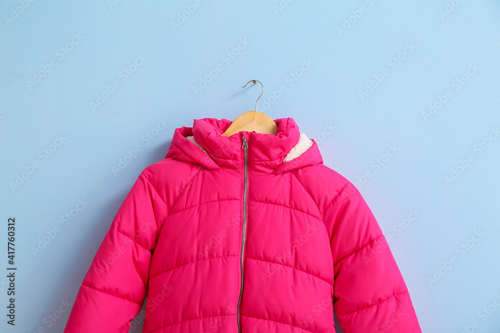 Hanger with stylish clothes on color background Hanger with stylish clothes on color background