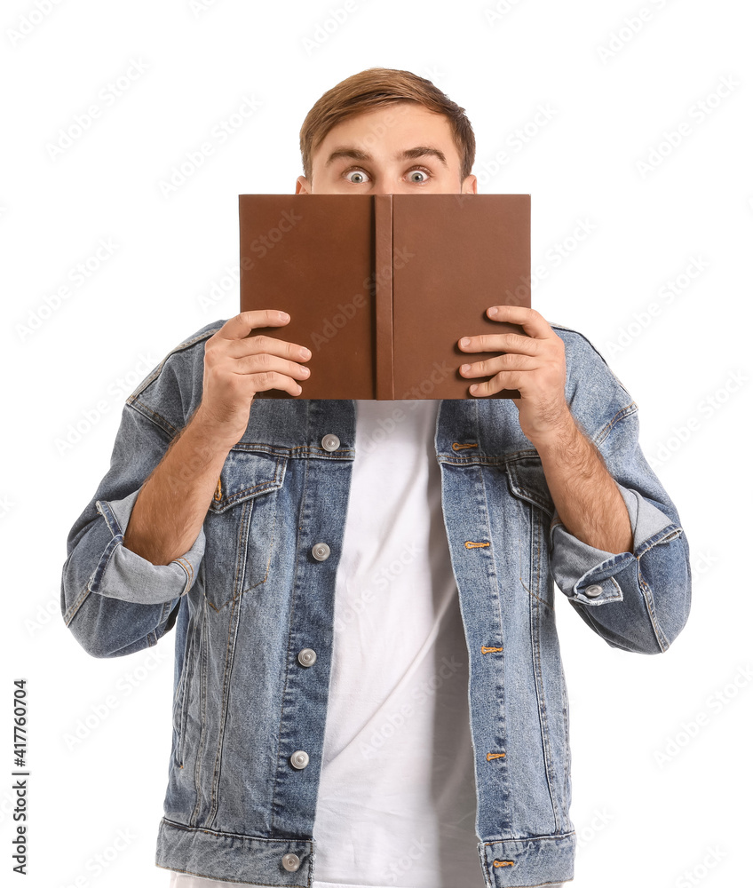 Fototapeta premium Surprised young man with book on white background