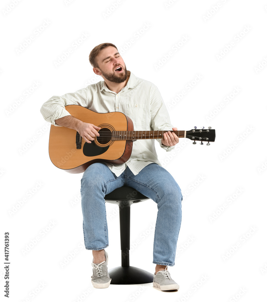 Young man playing guitar on white background Young man playing guitar on white background