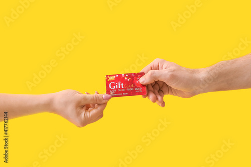 Hands with gift card on col...