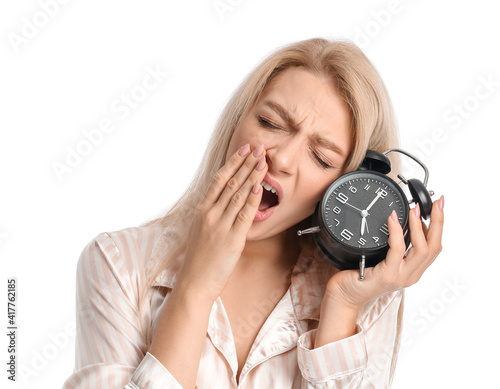 Sleepy young woman in pajam...