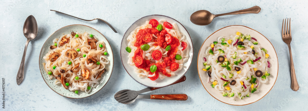 Konjac pasta panorama, shot from the top. Dishes of low-calorie pasta with various toppings Konjac pasta panorama, shot from the top. Dishes of low-calorie pasta with various toppings