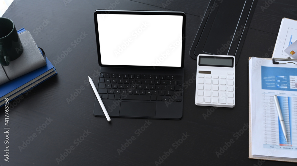 Overhead shot of accountant workplace with computer tablet calculate and business document on black office desk. Overhead shot of accountant workplace with computer tablet calculate and business document on black office desk.