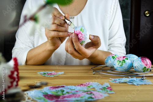 How to decorate an Easter egg with decoupage technique. The girl glues a napkin to the egg. Step by step, tutorial. Step 3