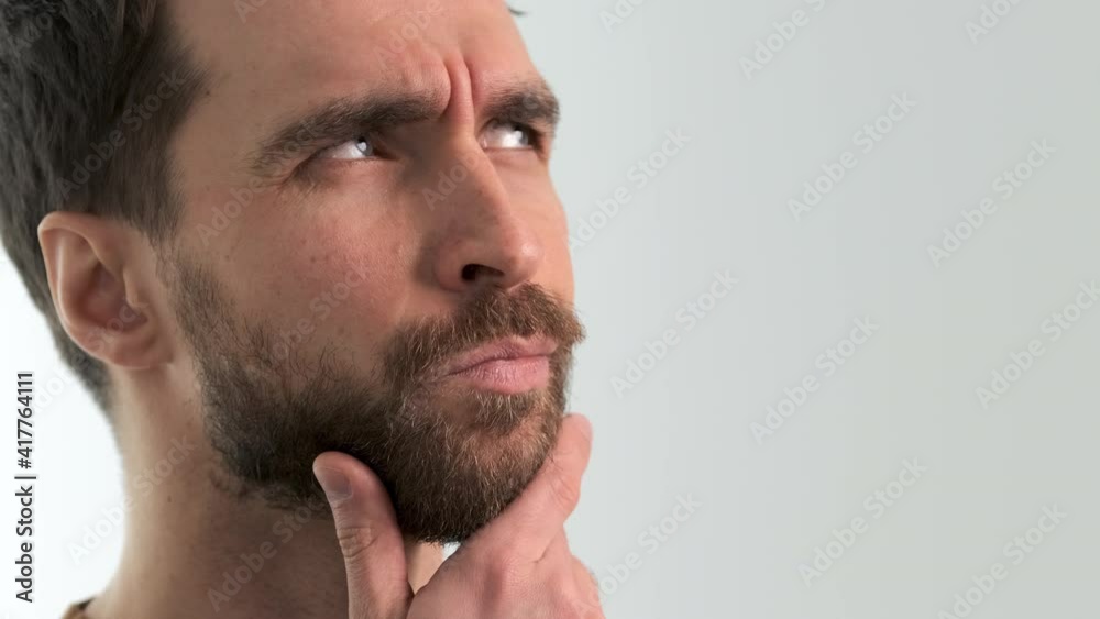 The handsome bearded man posing on camera indoor. slow motion The handsome bearded man posing on camera indoor. slow motion