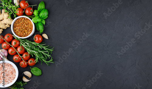 Colorful various herbs and spices for cooking on dark background, copy space, mock up, banner