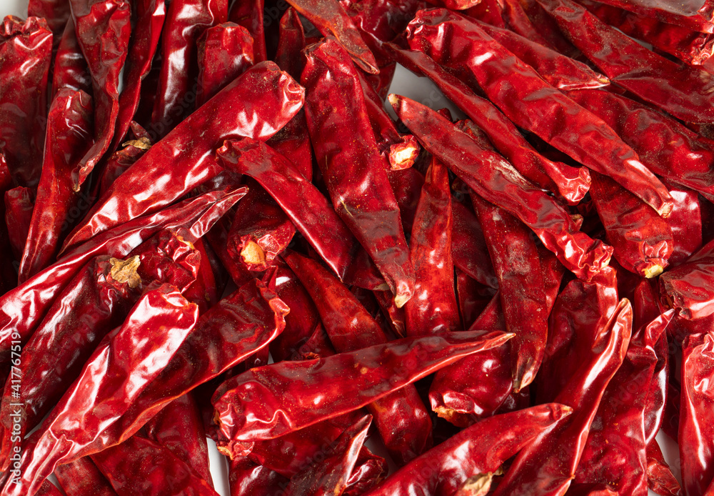 Dried Red Chili Peppers with Red Chili Powder isolated on White Background Dried Red Chili Peppers with Red Chili Powder isolated on White Background