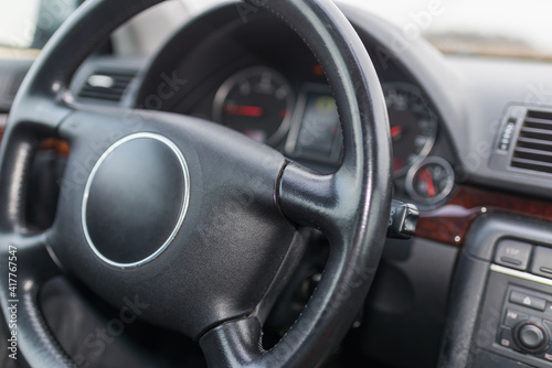 Dark car Interior. Steering wheel, dashboard. climate control, speedometer, display.From above image. © ARVD73