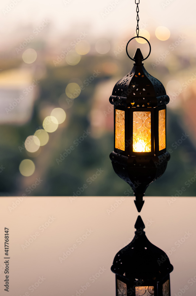 Hanging lantern with dusk sky and city bokeh light background for the Muslim feast of the holy month of Ramadan Kareem. Hanging lantern with dusk sky and city bokeh light background for the Muslim feast of the holy month of Ramadan Kareem.