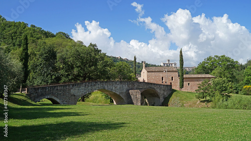 Historic bridge and Santa Croce church, popular landmark in Assisi, Italy