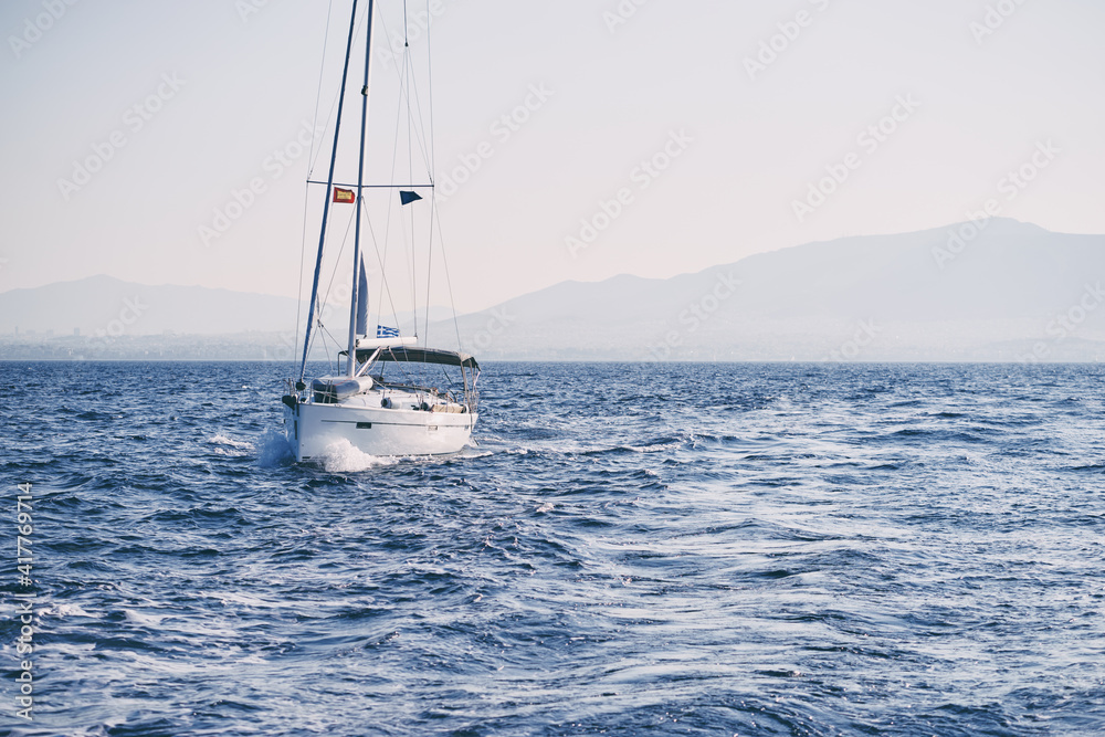 Fototapeta premium Beautiful white yaht sailing the sea.