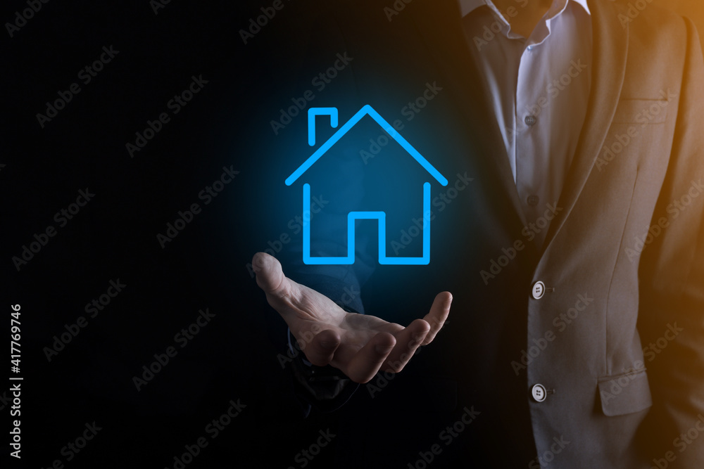 Real estate concept, businessman holding a house icon.House on Hand.Property insurance and security concept. Protecting gesture of man and symbol of house. Real estate concept, businessman holding a house icon.House on Hand.Property insurance and security concept. Protecting gesture of man and symbol of house.