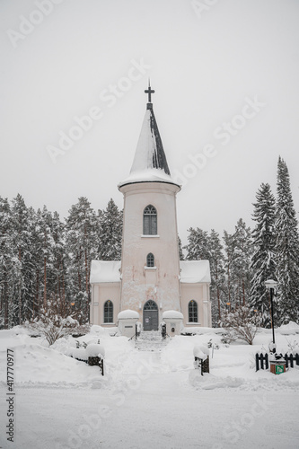 Small chapel church in woods during snowy winter